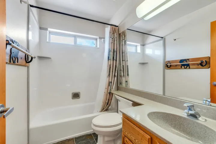 Bathroom with vanity and shower / tub combo