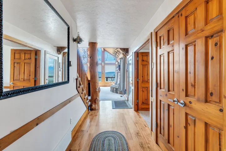 Hallway with light wood-style flooring and a textured ceiling