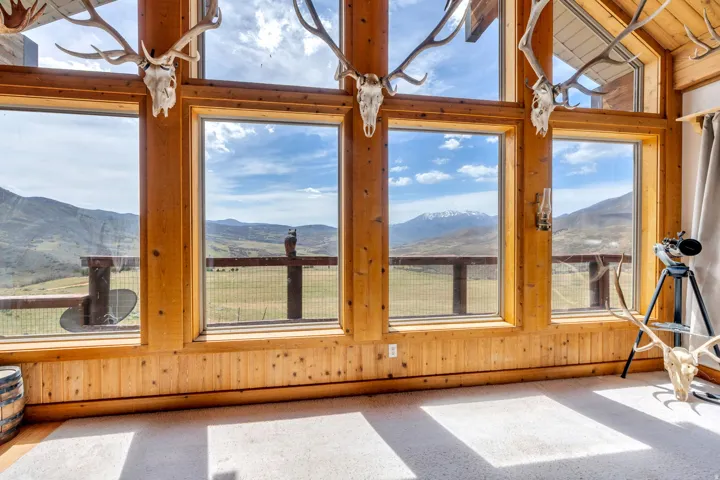 Sunroom / solarium with a mountain view and lofted ceiling