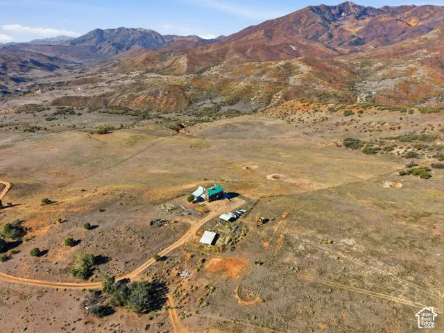 Expansive acreage featuring a mountain backdrop, open terrain, and unpaved access paths