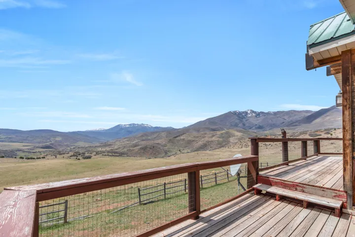 Deck with a mountain view and a view of countryside