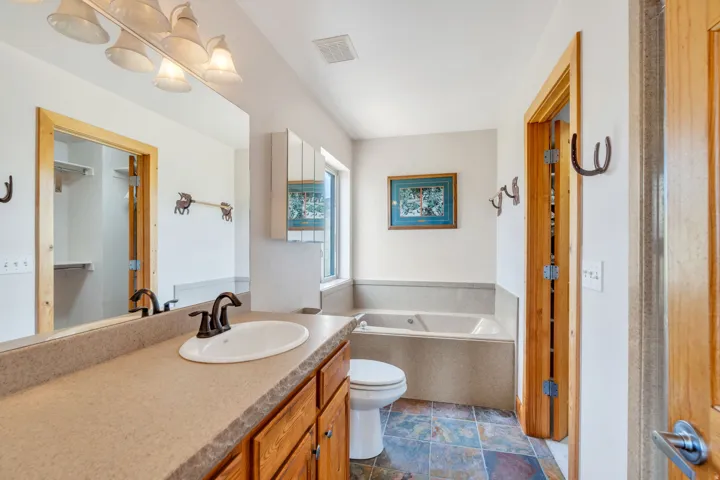 Bathroom featuring a bath and vanity