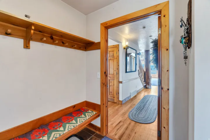 Hallway with wood finished floors and baseboards