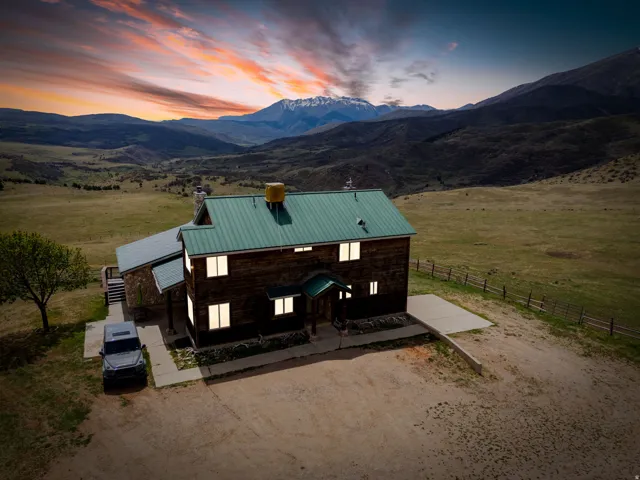 View of front facade with a view of countryside, a chimney, a mountain view, and a standing seam roof