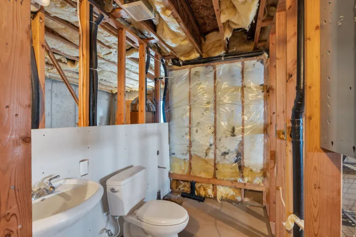 Half bathroom featuring toilet and a sink