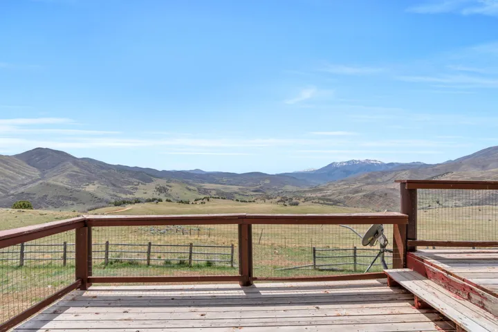 Deck with a mountain view and a view of countryside