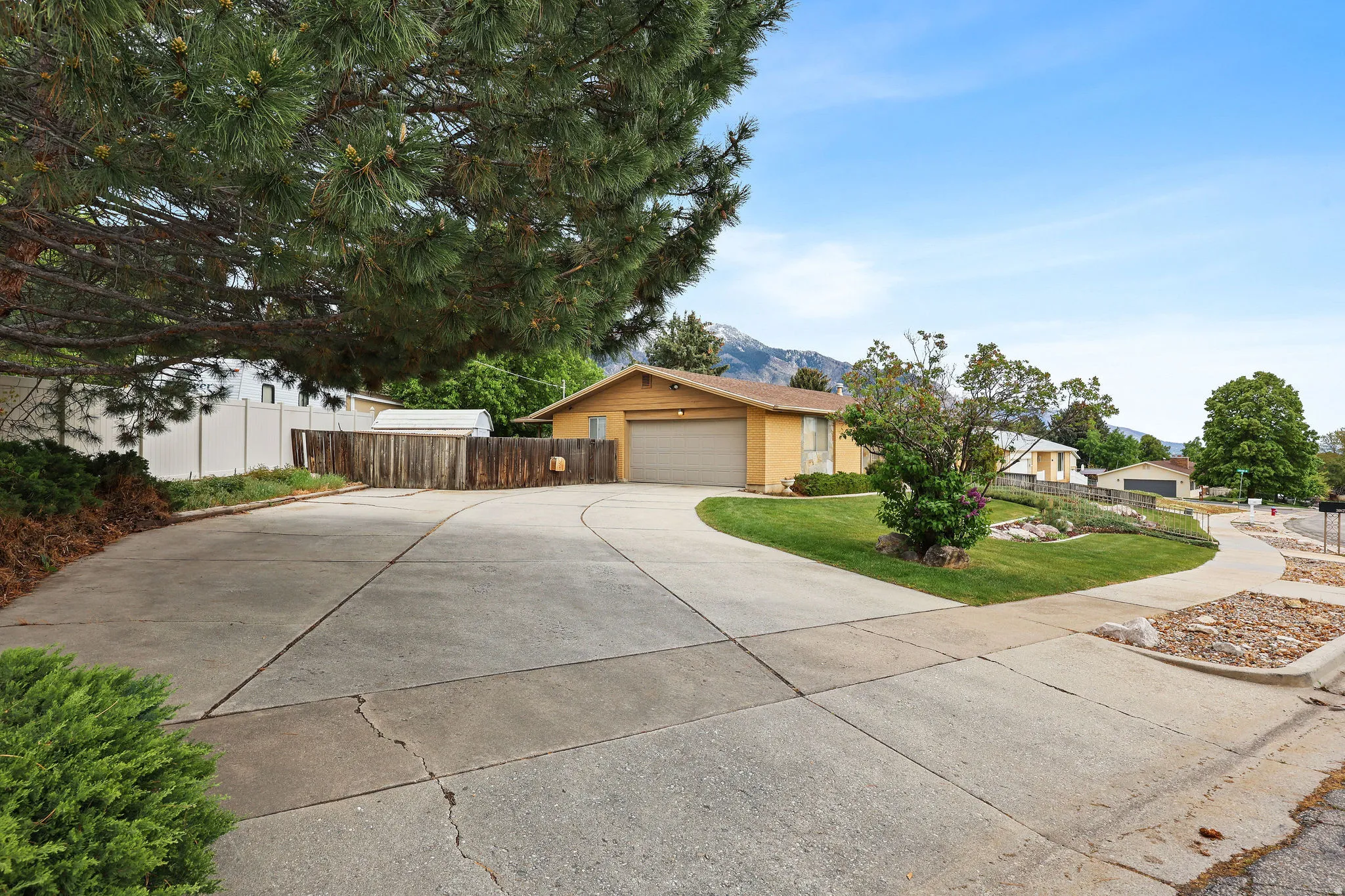 View of front of home featuring driveway, a mountain view, and a garage