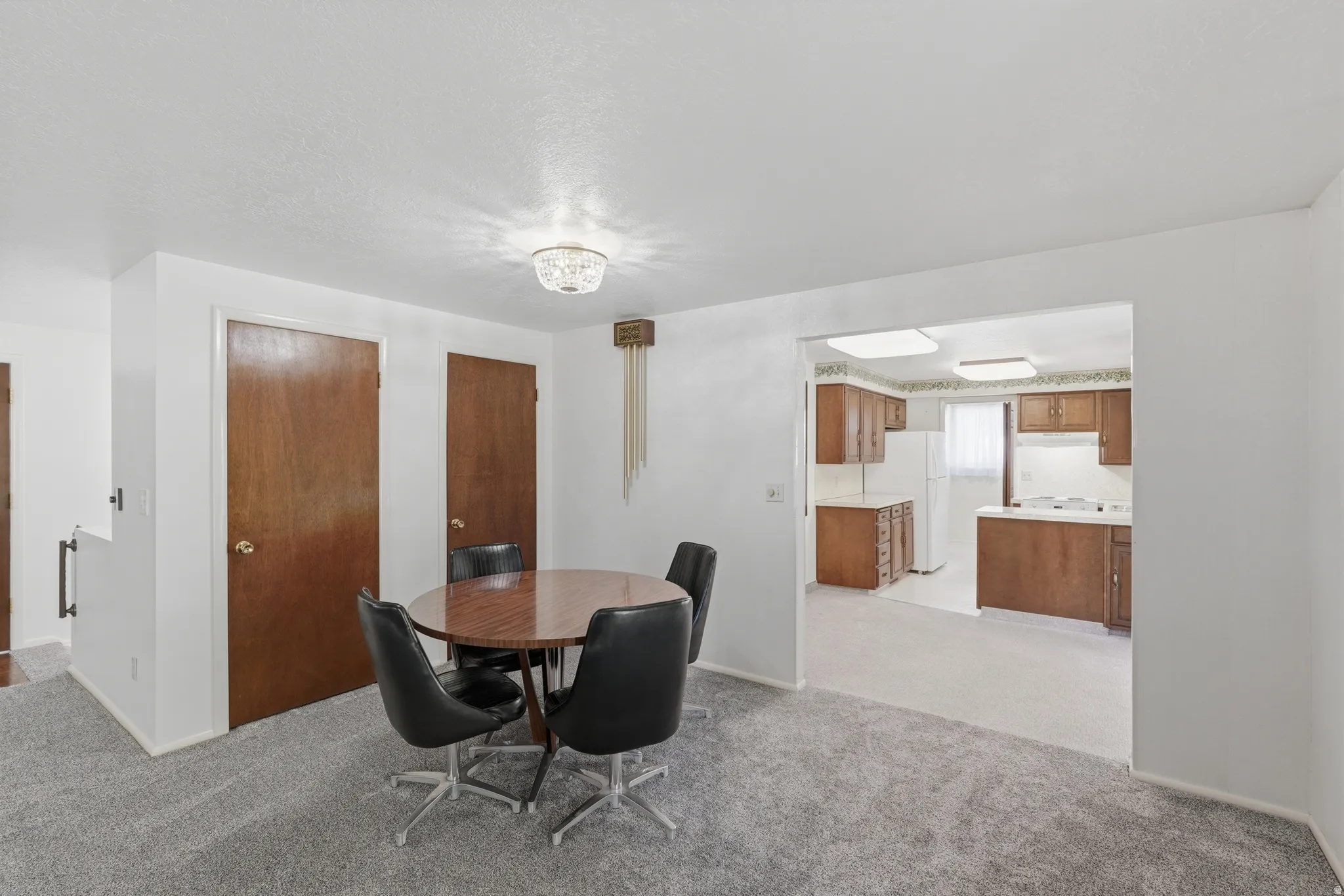 Dining area featuring a crystal flush-mount light fixture