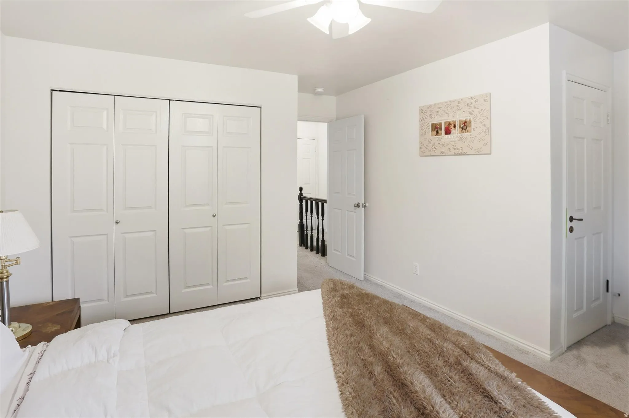 Bedroom with carpet flooring, a closet, and ceiling fan