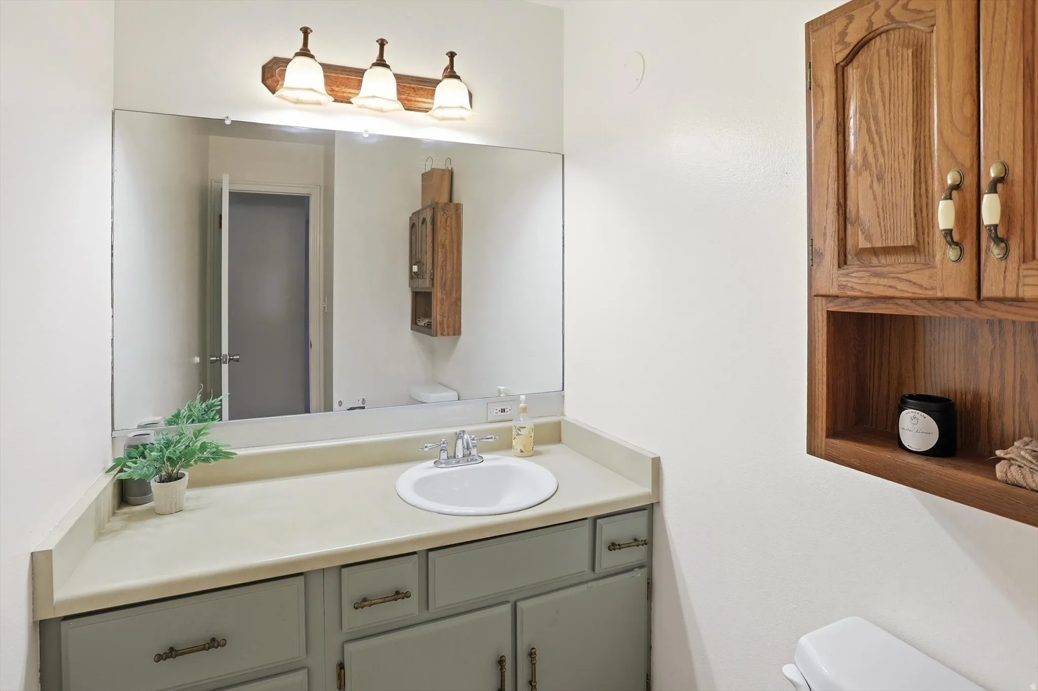 Half bath featuring toilet and vanity
