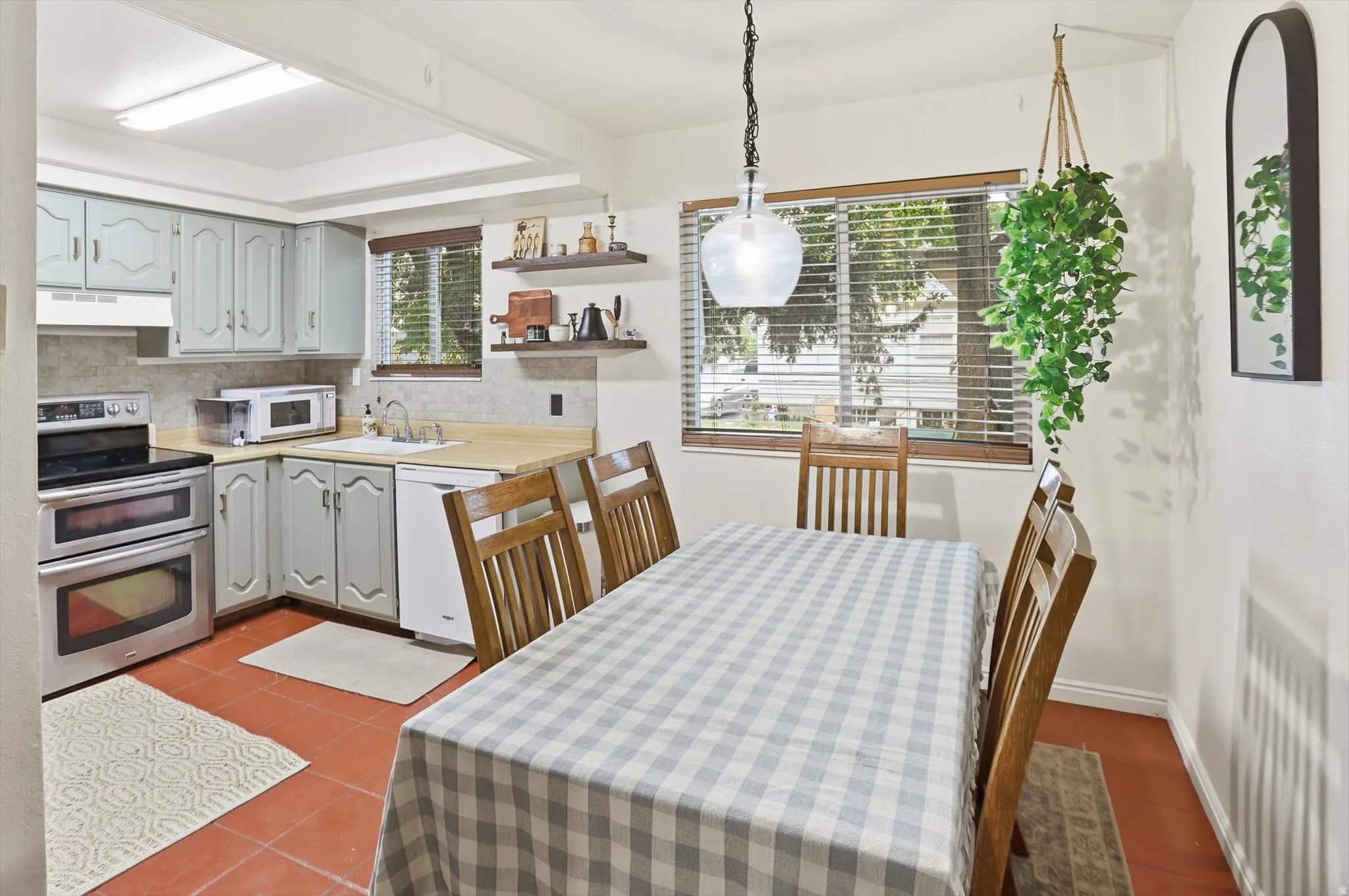 Dining space with dark tile patterned flooring