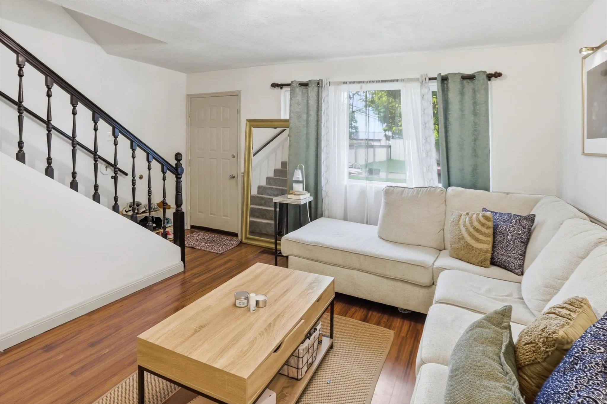 Living room featuring stairs and dark wood-type flooring