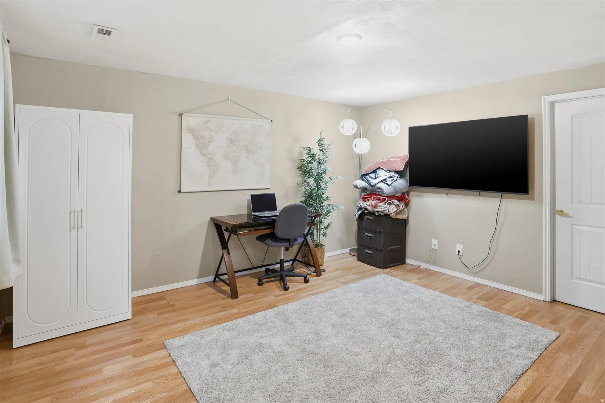 Office space featuring light wood-style flooring and baseboards