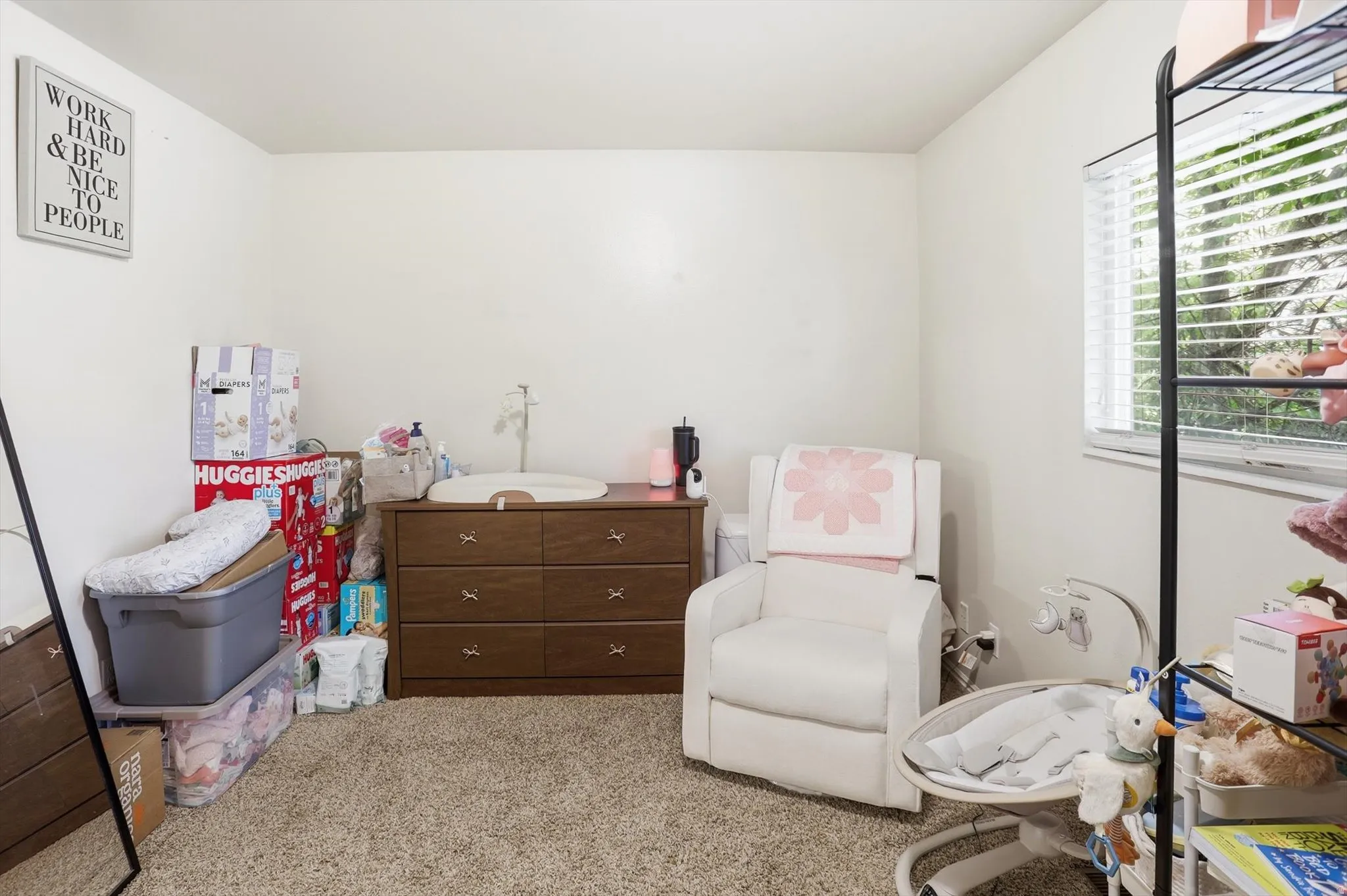 Bedroom featuring light colored carpet