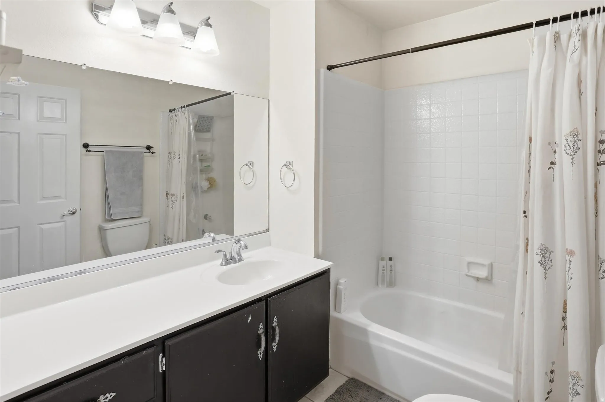 Full bathroom featuring vanity and shower / tub combo
