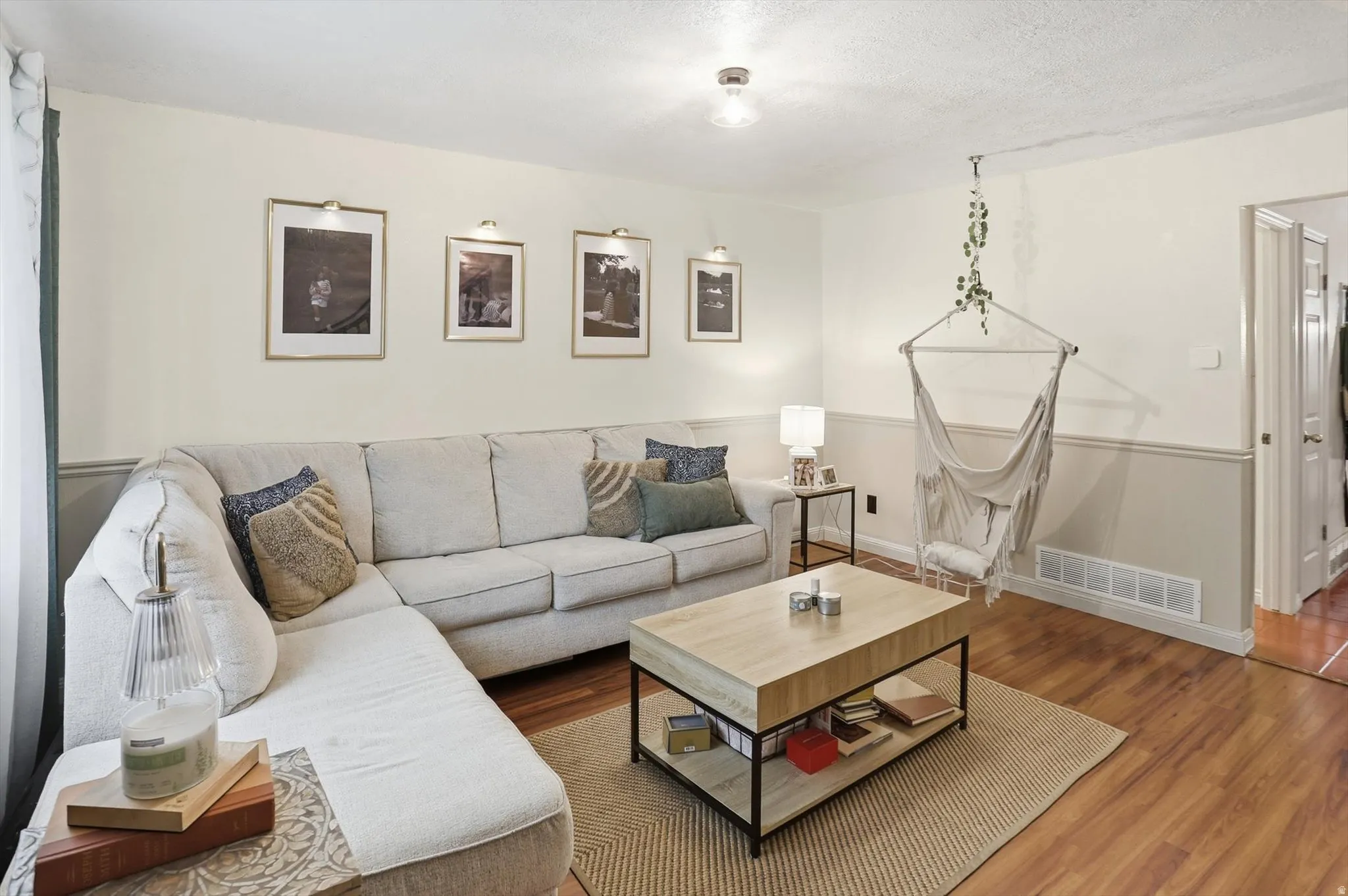 Living area with wood finished floors and a textured ceiling