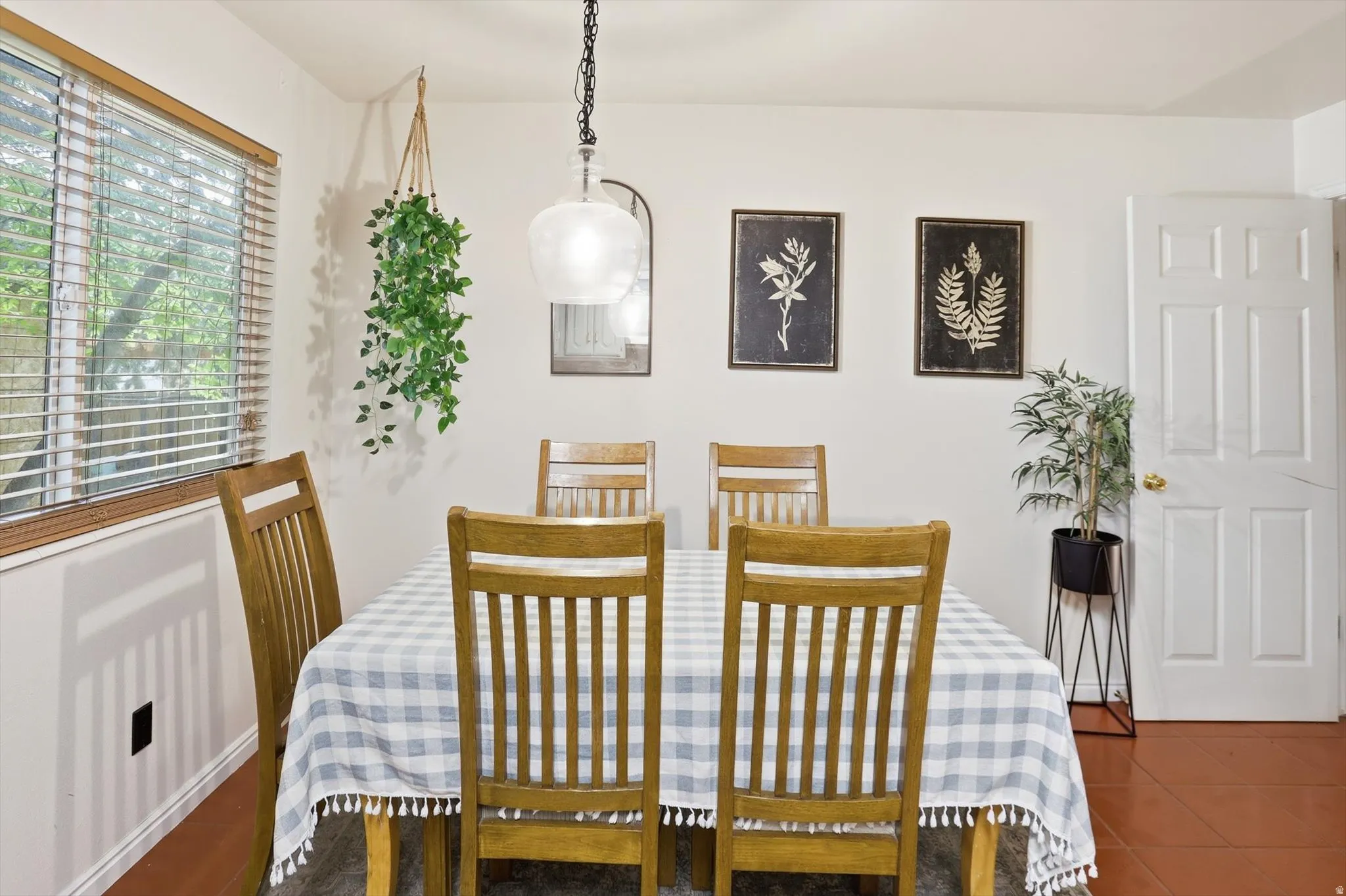Dining area with dark tile patterned floors