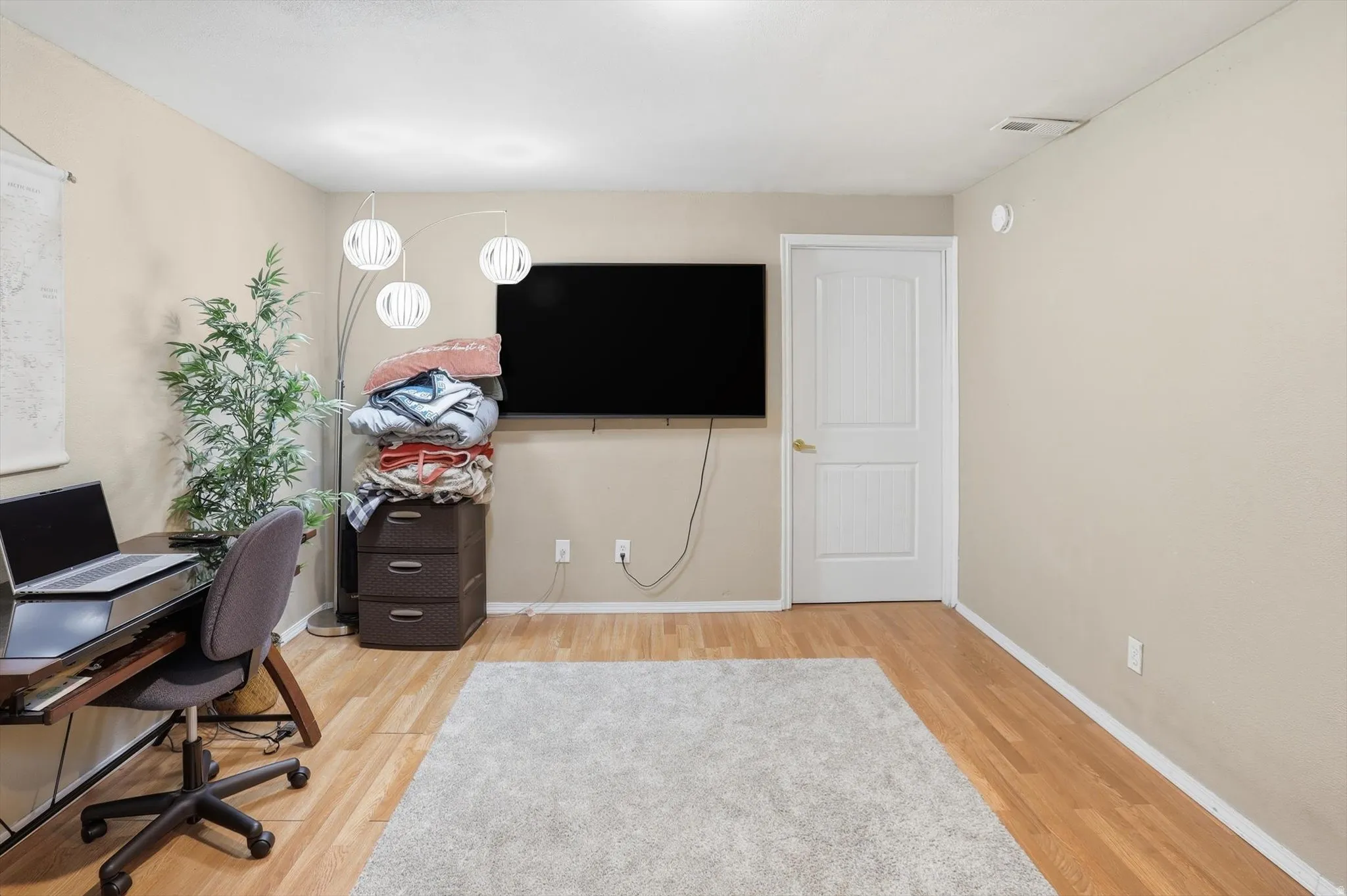 Office space with light wood finished floors and baseboards