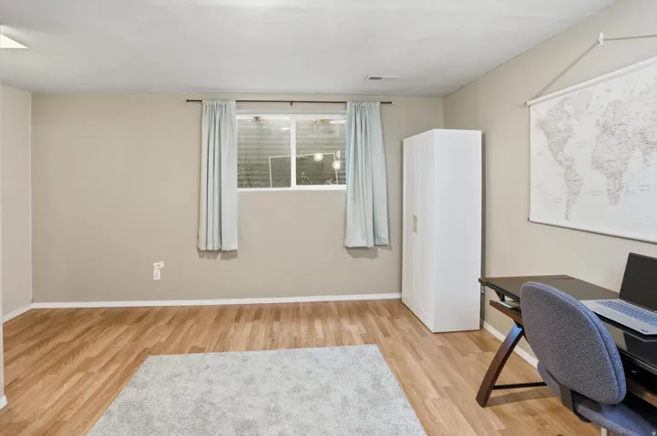 Home office with light wood-style floors and baseboards