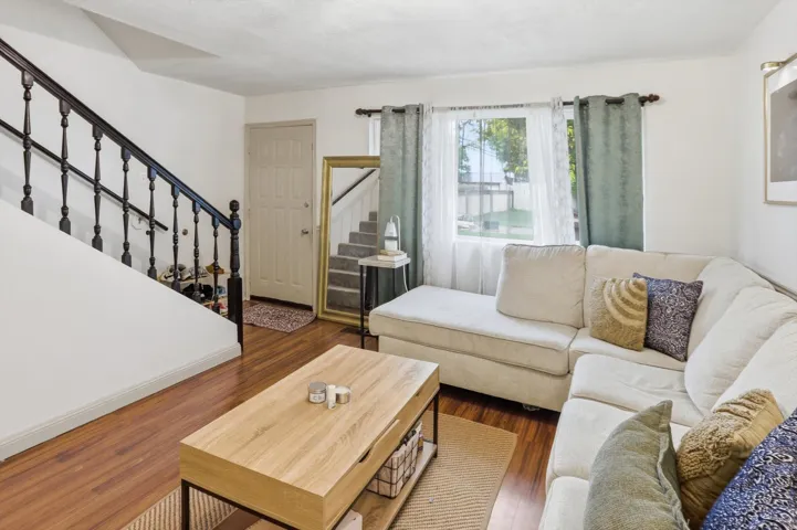 Living room featuring stairs and dark wood-type flooring