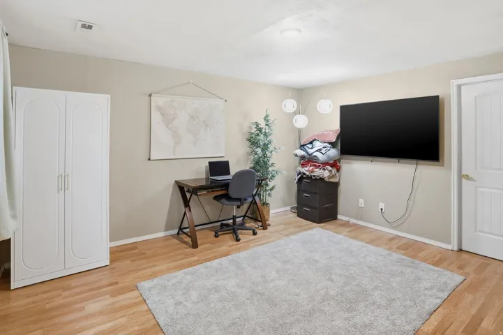Office space featuring light wood-style flooring and baseboards
