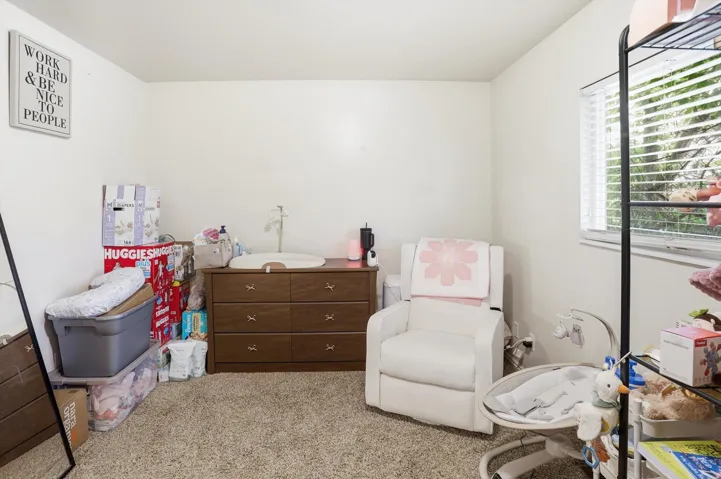 Bedroom featuring light colored carpet