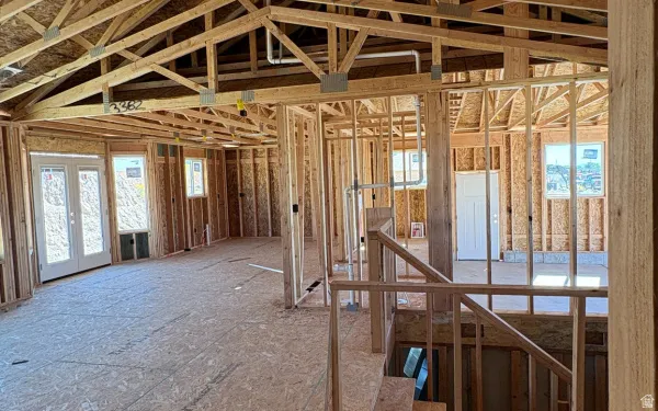 Misc room featuring an upstairs landing, plenty of natural light, and french doors