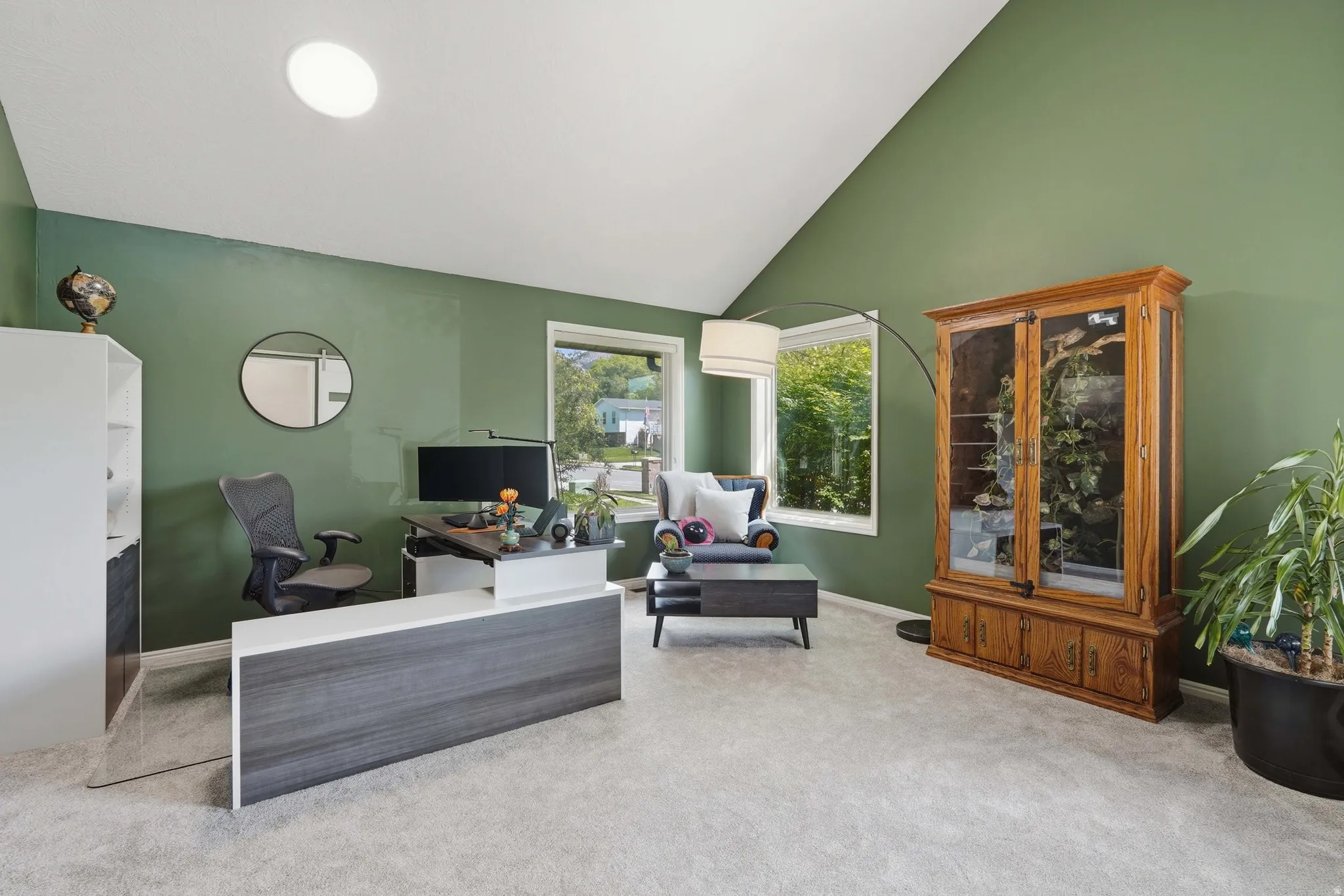 Living room / Office Space just off the entry with lofted ceiling and light colored carpet