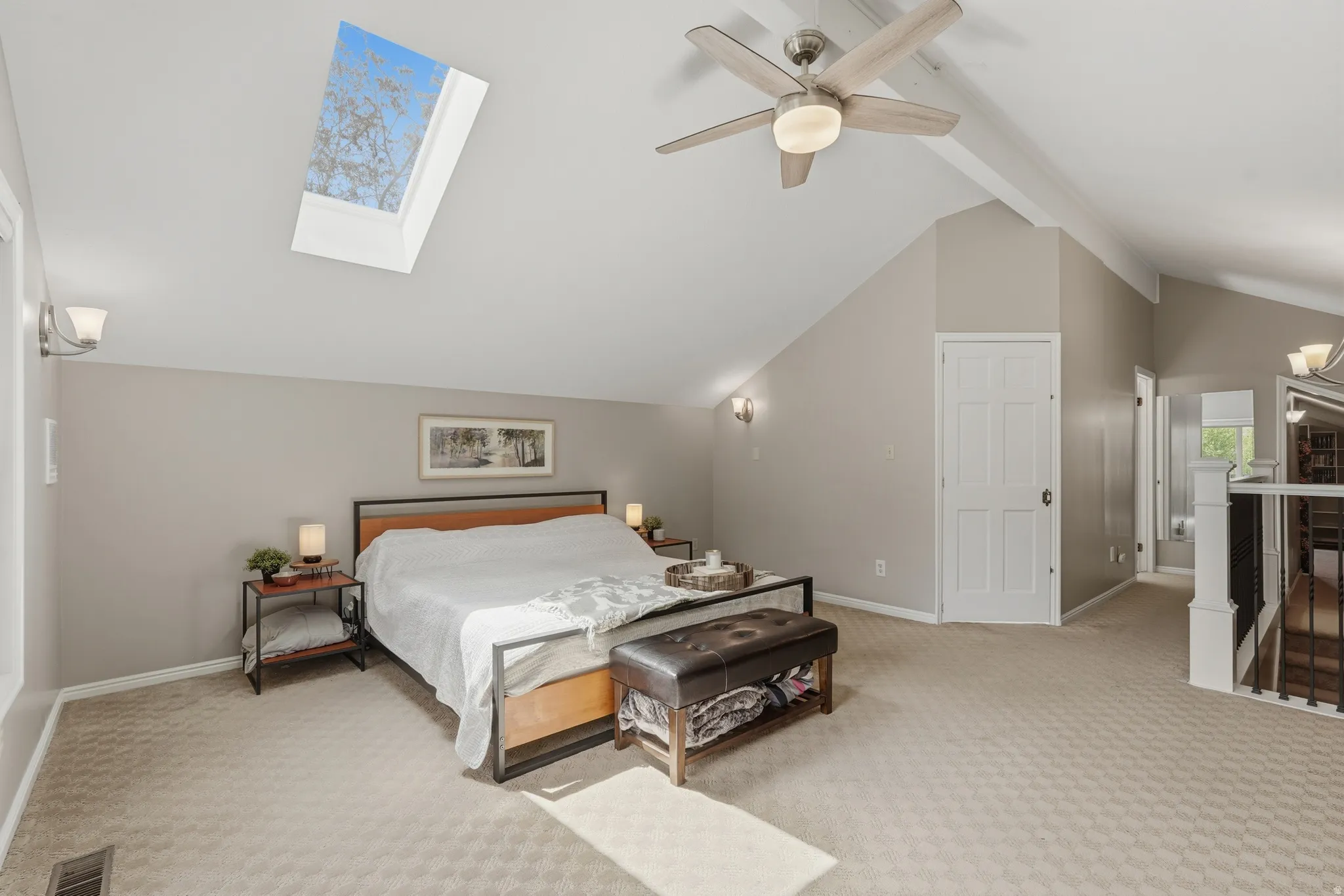 Primary Bedroom featuring a skylight, access to exterior balcony.