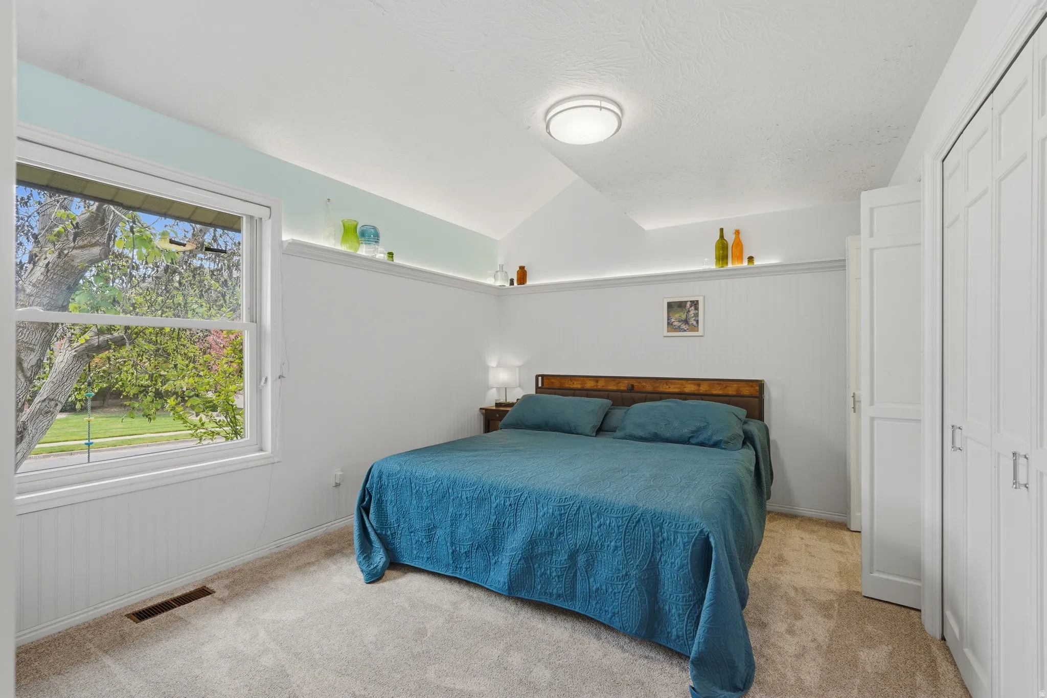 Bedroom with lofted ceiling, and ensuite bathroom