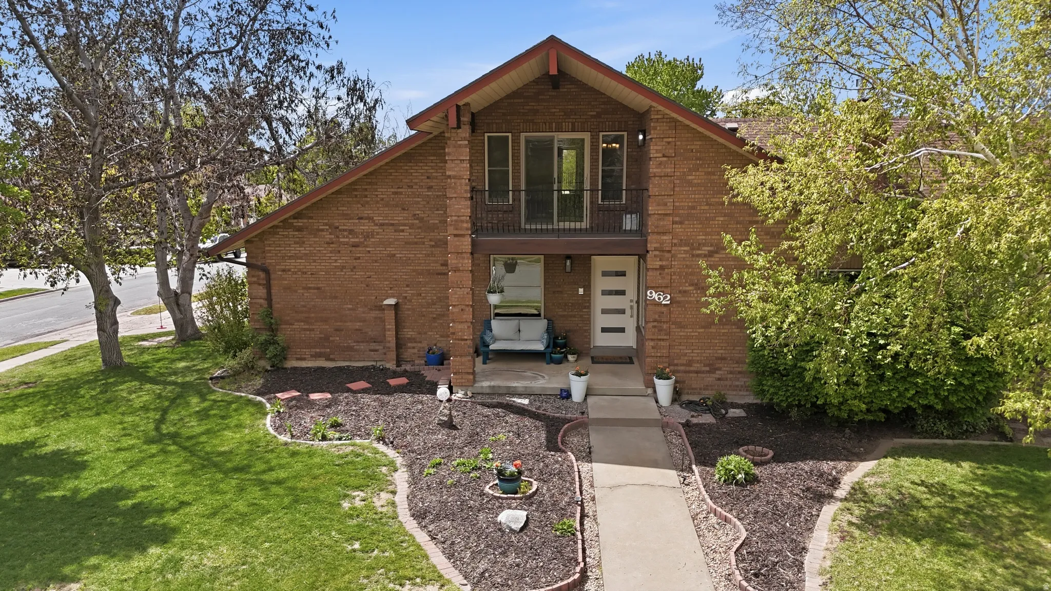 View of front of property featuring brick siding and a front yard