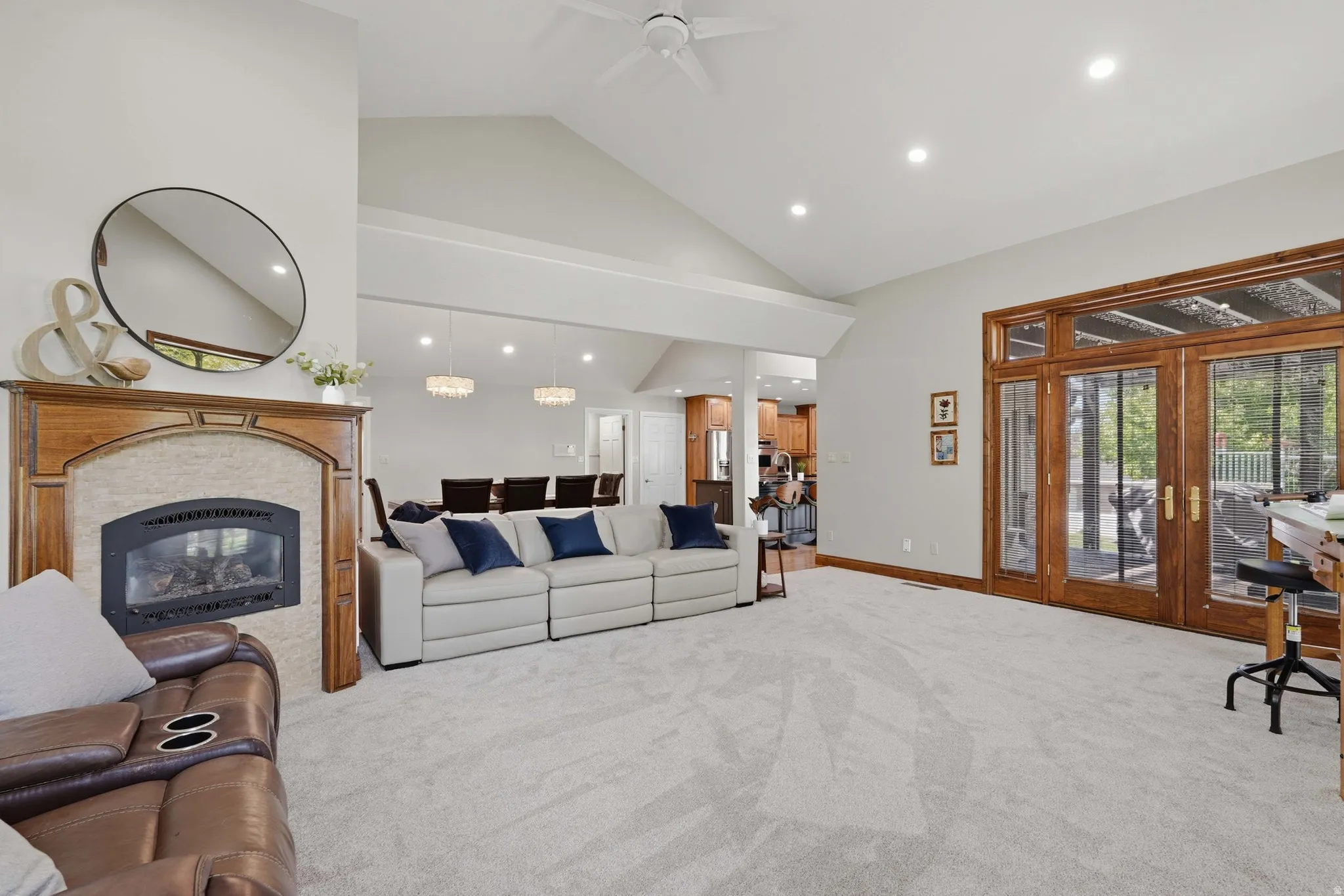 Great room featuring a high ceiling, fireplace, French door access to covered patio