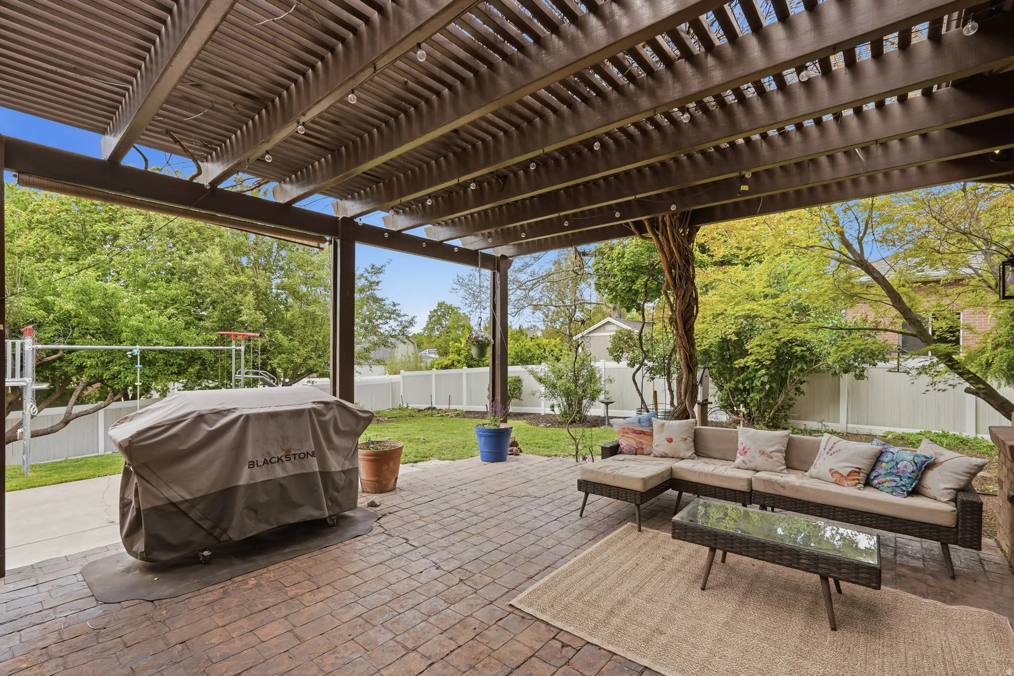 Fenced backyard featuring a pergola, area for grilling, outdoor furniture, and a patio area