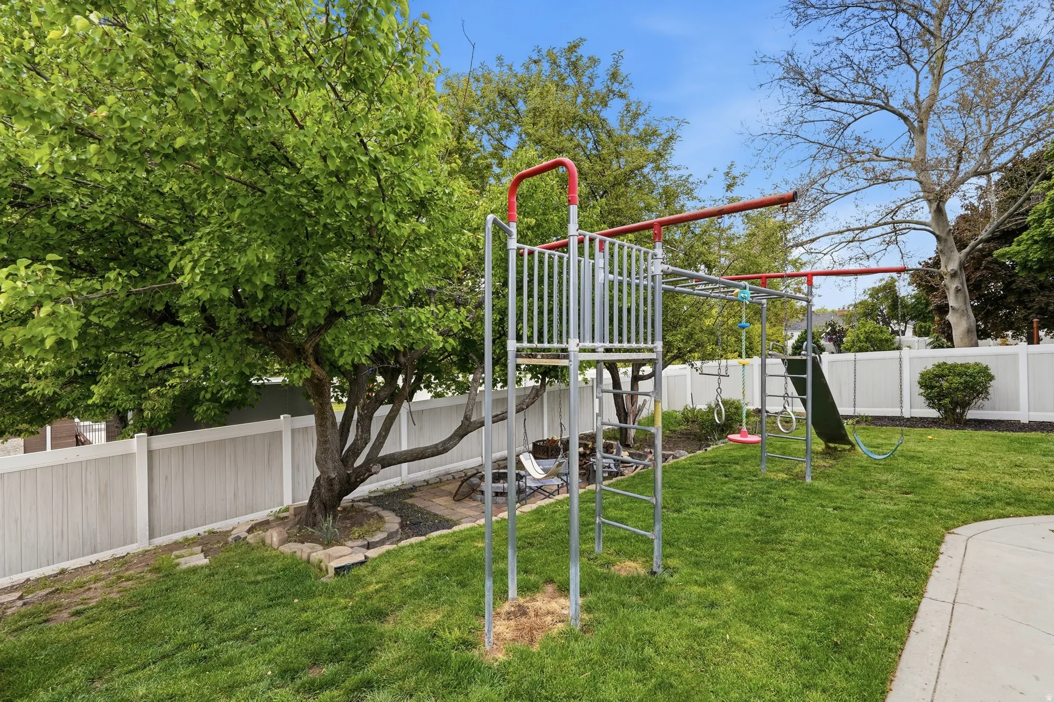 Fenced backyard with a playground