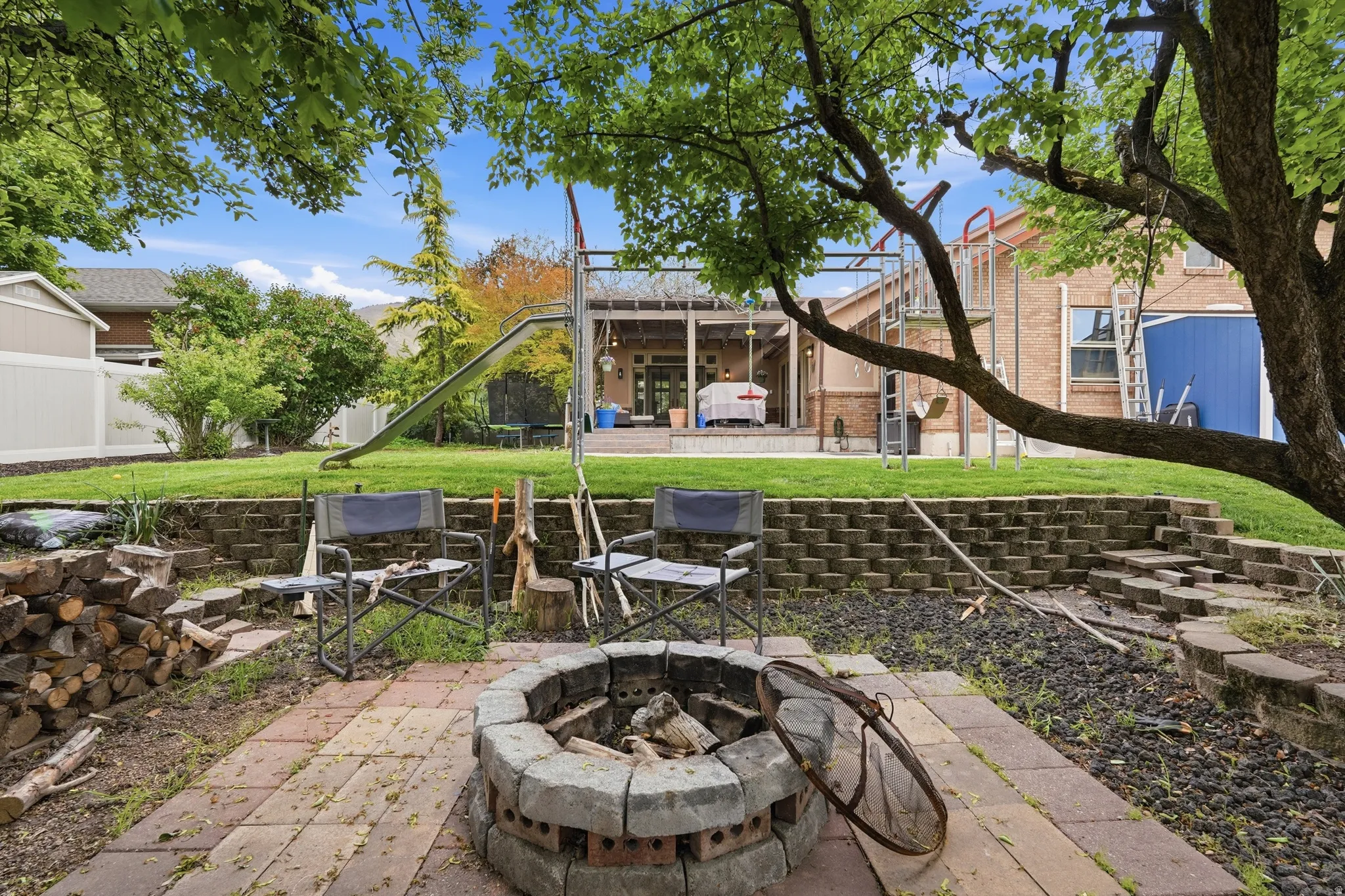View of patio / terrace featuring an outdoor fire pit and stairs