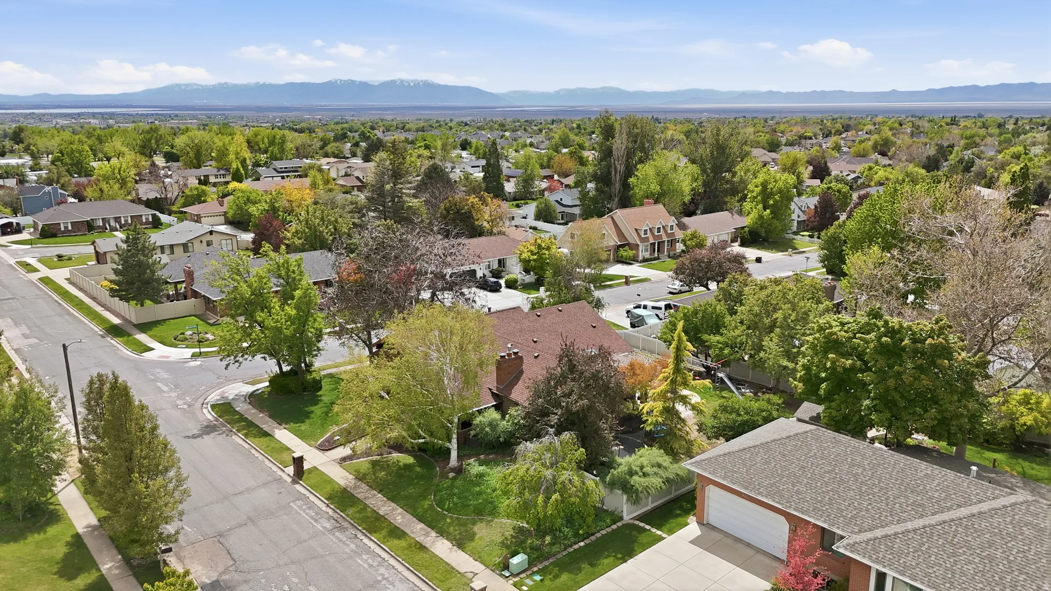 Aerial perspective of suburban area featuring a mountain backdrop