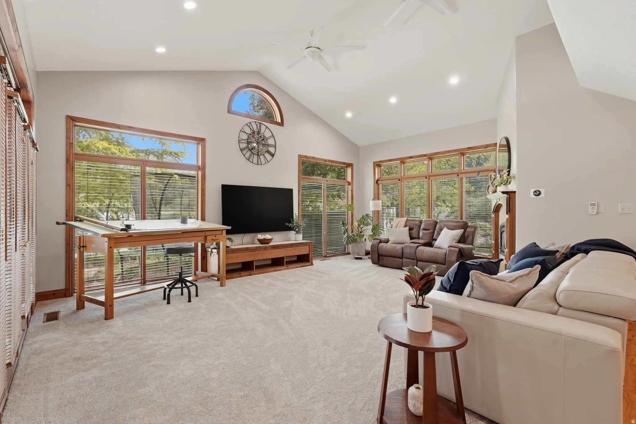 Great room featuring a high ceiling, fireplace, French door access to covered patio