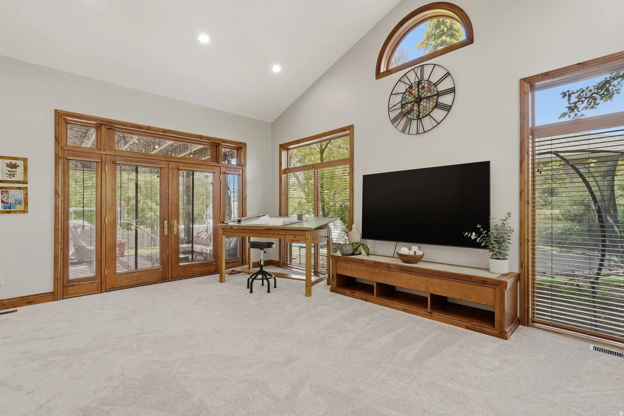 Great room featuring a high ceiling, fireplace, French door access to covered patio