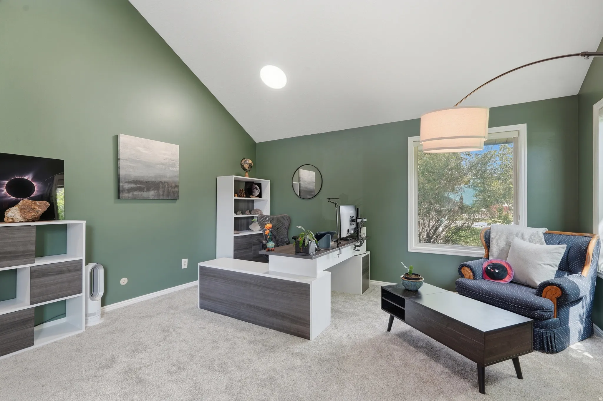 Living room / Office Space just off the entry with lofted ceiling and light colored carpet