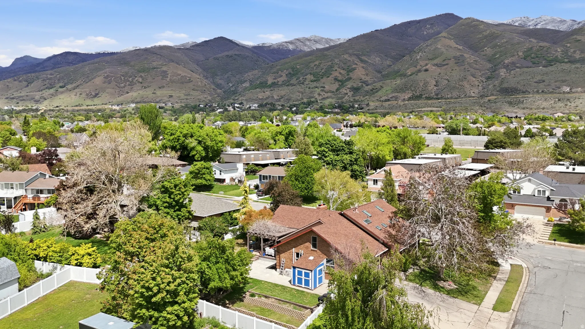 Aerial perspective of suburban area featuring a mountainous background