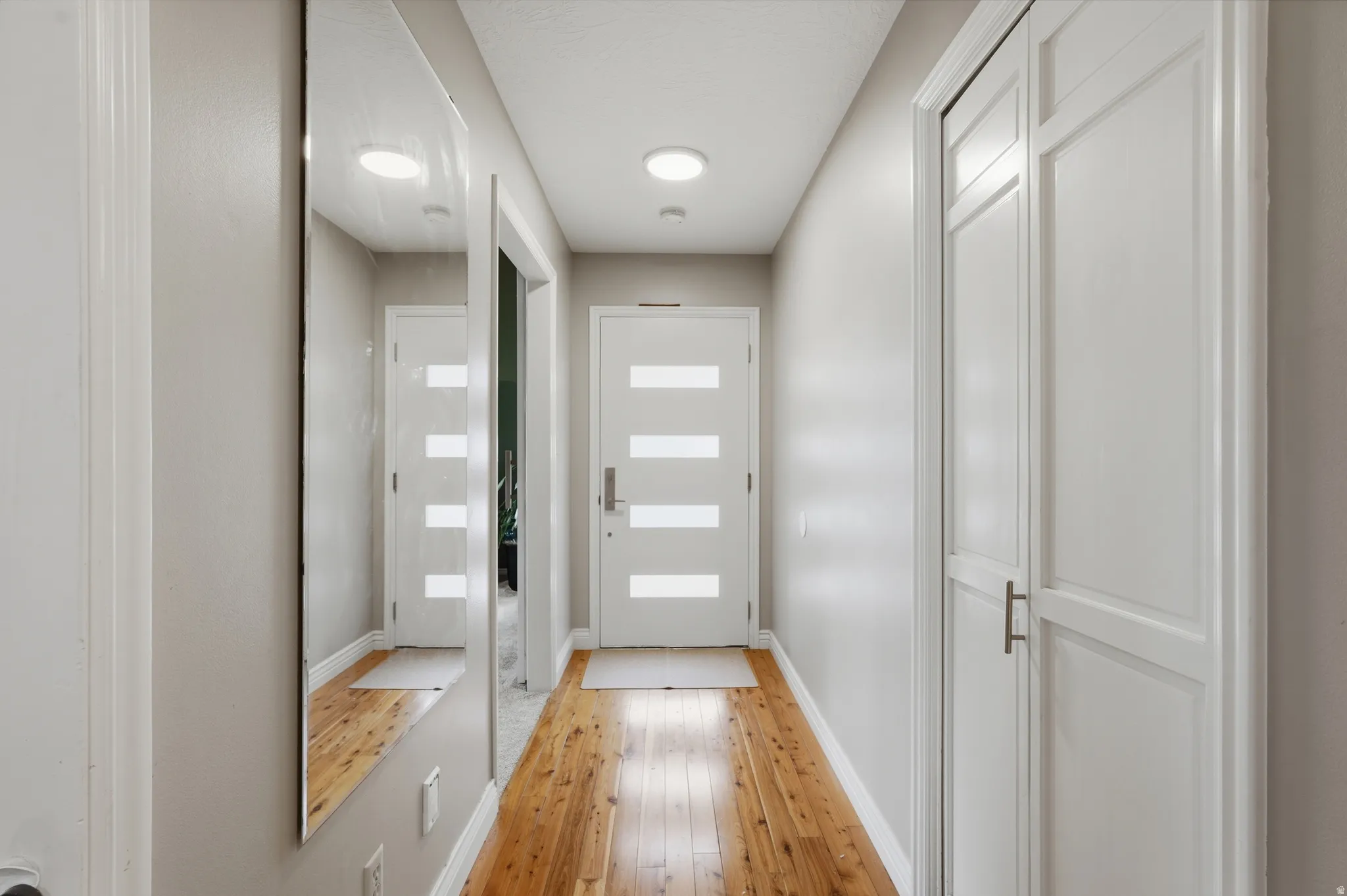 Entryway featuring hardwood / wood-style floors and baseboards