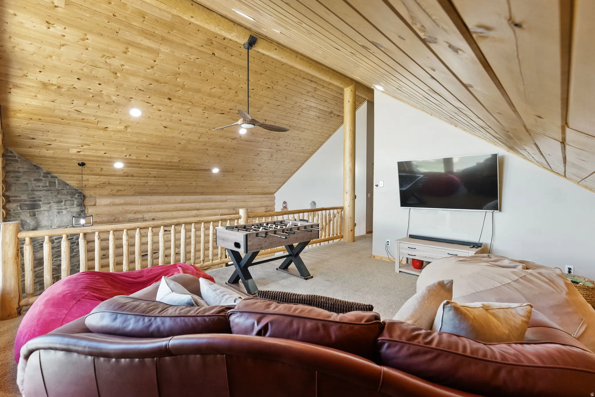 Playroom with recessed lighting, a wood ceiling with exposed beams, carpet flooring, rustic walls, and ceiling fan