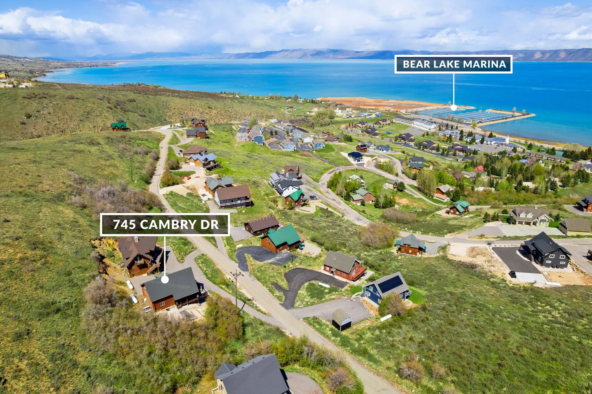 Aerial view of residential area with a nearby body of water and property boundaries highlighted