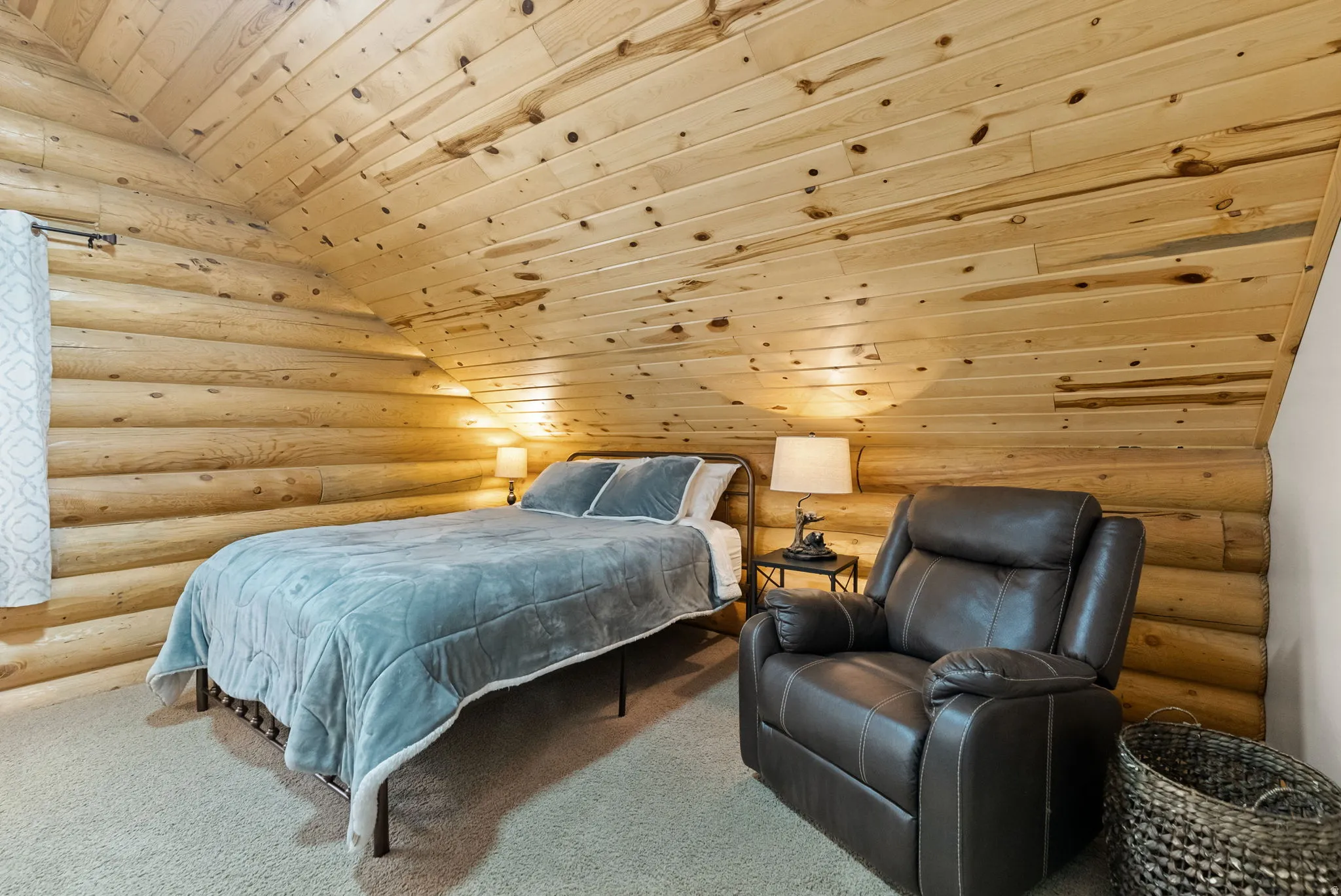 Bedroom featuring rustic walls, a vaulted wood ceiling, and carpet floors