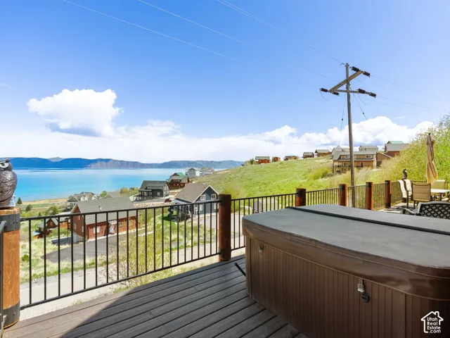 Deck with a mountain view and a hot tub