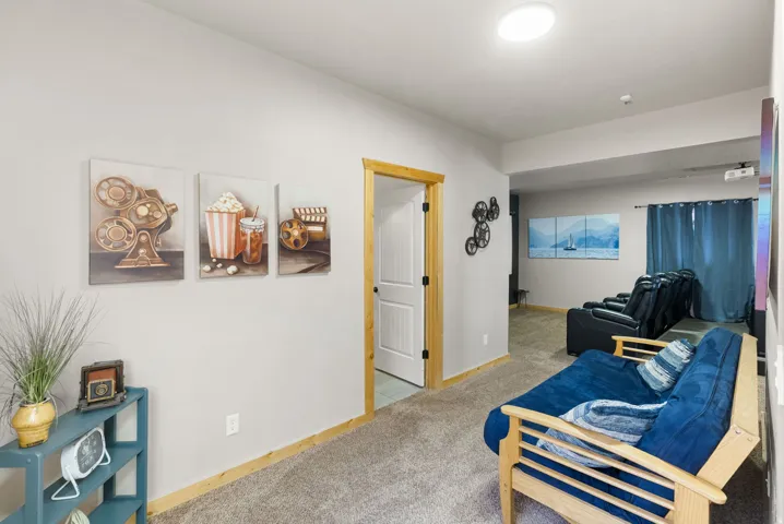 Sitting room featuring light carpet and baseboards