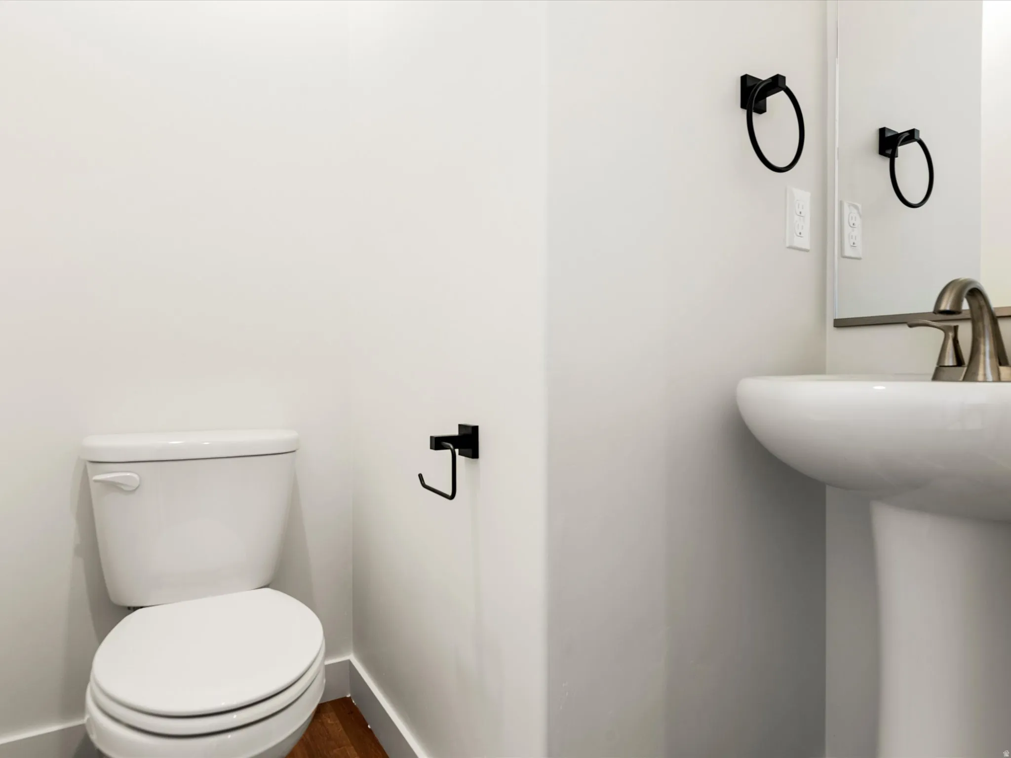 Bathroom with toilet and dark wood-style flooring