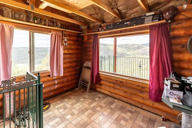 Sunroom featuring a water and mountain view