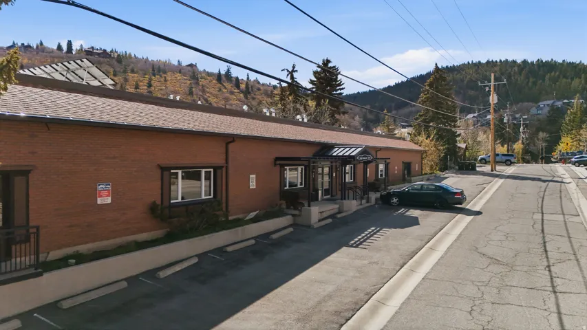 View of building exterior with uncovered parking