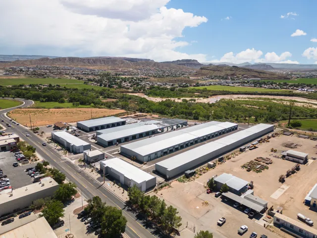Aerial view of industrial structures and a mountainous background
